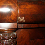 The front of this drawer has been damaged. It would take too long to determine if it is simply finish damage or if the veneer is also damaged. Just be aware of it.