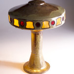 Bearing both Fulper and Vase-Kraft stamped marks, this pottery table lamp is a rare find. The shade contains red and yellow leaded slag glass inserts. Image courtesy of Rago Arts and Auction Center and Live Auctioneers Archive.