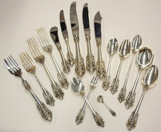 Sterling silver flatware in Clars’ sale includes 350 pieces of Wallace Grand Baroque in a custom-made teak chest. The extensive set has a $10,000-$15,000 estimate. Image courtesy of Clars Auction Gallery.