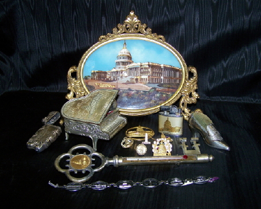 A few of the 575 items in the world’s largest private collection of Capitol Building memorabilia. Shown here: an ornate plaque, a shoe, miniature piano, key and other items, each displaying the iconic building. Estimate $2,000-$4,000. Image courtesy Cohasco Inc.