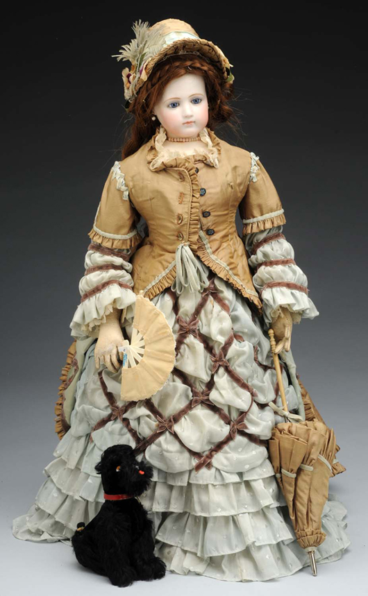 Circa-1870 poupee peau fashion lady, 21 inches, with original kid body and bisque socket head by Emile Jumeau. Beautifully and appropriately redressed, including parasol and French poodle. Estimate $4,000-$5,000. Image courtesy Dan Morphy Auctions.