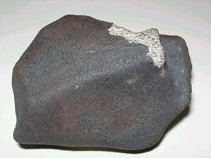 The example shown here is the Marília Meteorite, a chondrite H4, that fell in Marília, São Paulo state, Brazil, on October 5, 1971. Image courtesy Wikimedia Commons.