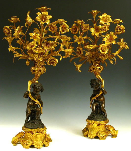 This pair of mid-19th century six-light candelabra with two different figures of cupid, a boy and a girl, both hold gilded bronze floral bouquets. Each measures 28 1/2 inches high and approximately 17 inches across. The estimate is $1,000-$3,000. Image courtesy of Dirk Soulis Auctions.