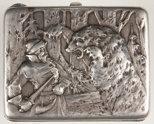 A collection of Russian cigarette cases includes this silver example with a hinged lid repoussed with a woodsman being attacked by a bear. Having the maker's mark of Ivan Krutikov, Moscow, it dates to 1908-1917. It has a $600-$800 estimate. Image courtesy Jackson’s International Auctioneers.