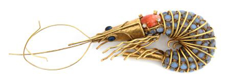 A stamped Iradj Moini gem set crawfish pin, 1983, with lavender, navy and clear poured glass in a gold-tone setting sold for $976 at Leslie Hindman’s Sept. 2, 2009 auction of vintage couture and accessories, against a presale estimate of $800-1,200. Image courtesy of Leslie Hindman Auctioneers.