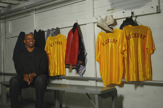 CBS basketball analyst Clark Kellogg prepares to deliver his lines for a video, which was videotaped at the Hoosier Gym in Knightstown, Ind. Kellogg is seated in the locker room where Hickory Huskers suited up for their home games in the movie ‘Hoosiers.’ Photo by Tom Hoepf.