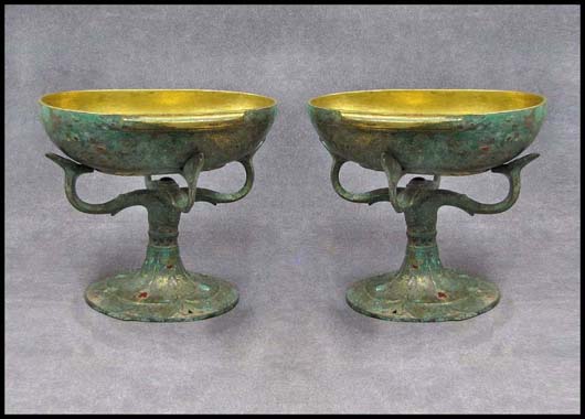 Gilding, hard stone mounts and gold and silver inlay are later additions to this pair of Han Period Chinese bronze ear cups with stands, estimate $10,000-$15,000). Image courtesy William Jenack Auctioneers.