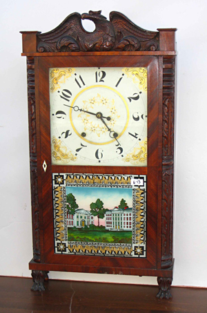 Carved case shelf clock by Eli Terry, Jr., featuring carved quarter columns flanking a full-length door. Image courtesy Gordon S. Converse.