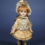 Amber brown paperweight eyes give this Jumeau bisque bebe a special look. Marked ‘Jumeau 3’ and with red painter's marks ‘C X II,’ the 11 1/2-inch doll has a $2,000-$3,000 estimate. Image courtesy of Skinner Inc.