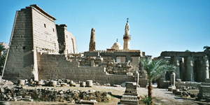 General view of Luxor Temple, front end, from the Corniche. Photo taken by Hajor, Dec. 2002. Released under cc.by.sa and/or GFDL. Image acquired through Wikimedia Commons.