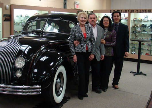 Joan and Dick Ford, Bertoia Auctions owner Jeanne Bertoia and her son, Bertoia Auctions associate Michael Bertoia pose with Dick’s immaculate 1934 Chrysler Imperial Airflow CV automobile, which sold for $43,700. Bertoia Auctions image.