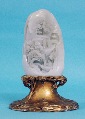 Carved during the 18th century, this large white jade mountain group is raised on a 20th-century carved giltwood base. It carries a $14,000-$18,000 estimate. Image courtesy of Auction Gallery of the Palm Beaches Inc.