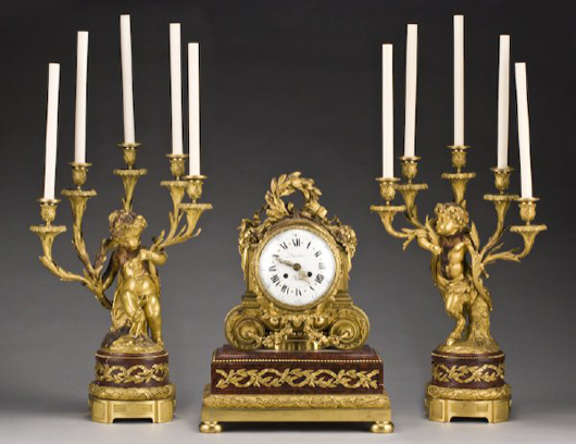 This Louis XV-style gilt bronze clock set dates to the second half of the 19th century. The enameled clock dial is signed ‘Duetertre A Paris.’ The three-piece set has a $5,000-$7,000 estimate. Image courtesy of Dallas Auction Gallery.