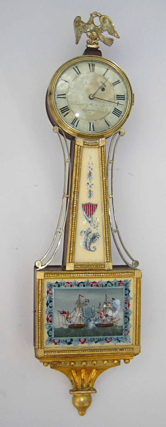 Curtis and Dunning of Vermont made this gilt wood and eglomise painted glass banjo clock, which sold for $3,162. Image courtesy of Gordon S. Converse & Co.