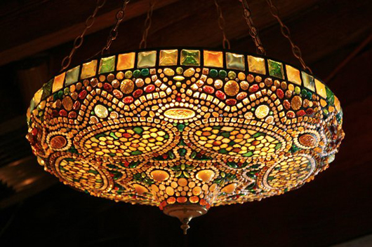 Art Nouveau-style leaded-glass lamp crafted entirely from Tiffany workshop glass, oval cartouches and attractive “studded motif,” 32-inch diameter, $32,940. Image courtesy LiveAuctioneers.com Archive and Guernsey's.