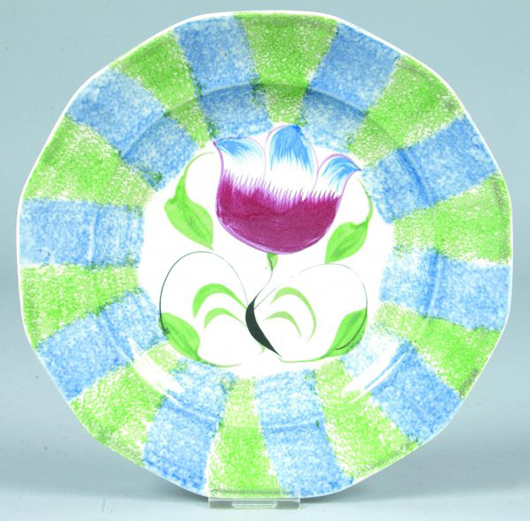 In very good condition, this beautifully decorated blue and green rainbow spatterware plate in the Tulip pattern could sell for $3,000-$5,000. Image courtesy of Conestoga Auction Co.