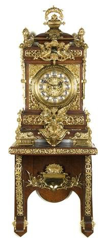 Pineapple form finials accent this 19th-century oak and gilt metal mounted bracket clock, which is 52 inches tall. It has a $20,000-$30,000 estimate. Images courtesy Leslie Hindman Auctioneers.