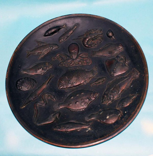 Sea life in relief covers this 26 1/4-inch Japanese iron charger of the late Meiji Period. It sold for $2,500. Image courtesy of Auction Gallery of the Palm Beaches Inc.