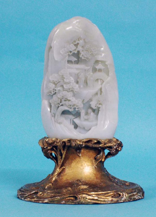 Carved during the 18th century, this large white jade mountain group on a 20th-century giltwood base sold for $16,000. Image courtesy of Auction Gallery of the Palm Beaches Inc.