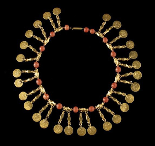 Big and bold jewelry was one of Luba Glade’s trademarks. This unusual Mideast 20K yellow gold and coral necklace, composed of gold faceted tubular links and faceted coral beads suspending imitation Arabic coins as drops. It has a $500-$800 estimate. Image courtesy New Orleans Auction Galleries Inc.