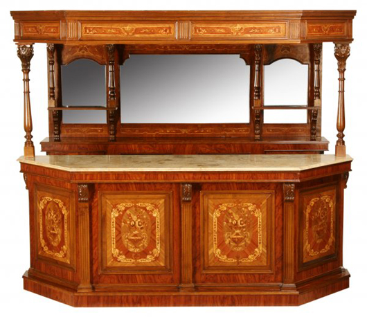 Marquetry inlay adorns this 8 1/2-foot-long pub bar. A wooden canopy connects the mirrored back bar with the marble-top serving counter. It has a $15,000-$25,000 estimate. Image courtesy of Great Gatsby’s Antiques and Auctions.
