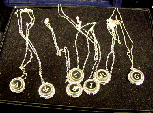 An assortment of necklaces featuring typewriter keys. Image courtesy Florida Antique Shows/Puchstein Promotions.