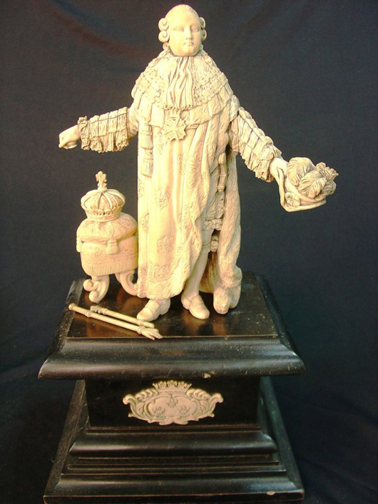 King Louis XIV is depicted in carved ivory. The statuette on ebony and a wooden base is 18 inches tall and has a $15,000-$40,000 estimate. Image courtesy of Stevens Auction Co.