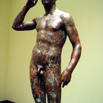 Victorious Youth, also known as the Getty Bronze, from the Hellenistic Period and depicting an athlete crowning himself. Photo taken 2-12-2006 by 3dnatureguy. Image appears courtesy of the photographer through Creative Commons GNU Free Documentation license.