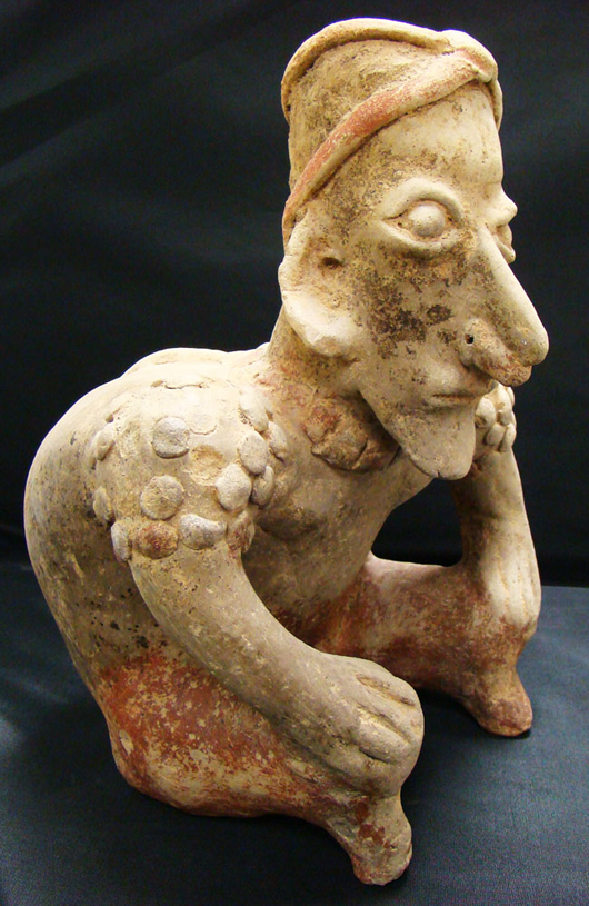 Jalisco, western Mexico, seated hunchback figure in creme ceramic, 12 inches, circa 250 BC - 350 AD, $2,500-$3,500. Image courtesy Malter Galleries.