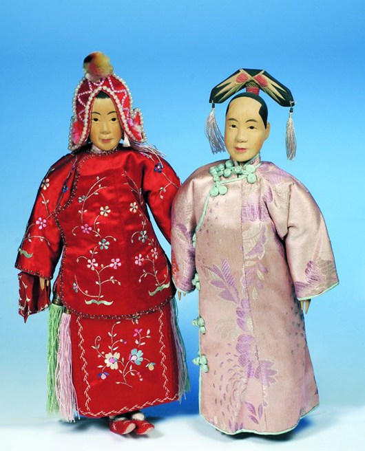 The Door of Hope carved wooden Manchu Lady, right, is all original and in pristine conditions. The 12-inch doll has a $4,000-$5,000 estimate. Image courtesy of Frasher’s Doll Auction.