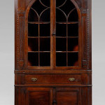 The original blue paint on this Swisegood corner cupboard can be seen under its orange and red painted surface. With rope-carved quarter columns, original brasses and original bracket feet, the cupboard sold for $120,750, a probable new record for a Southern corner cupboard. Image courtesy Brunk Auctions.