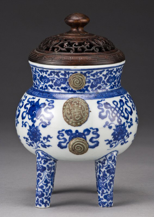 This Qing Qianlong Imperial blue and white porcelain He-shaped pot is finely painted to depict eight lucky symbols. It stands 9 1/4 inches high. Its estimate is $10,000-$20,000. Image courtesy Dallas Auction Gallery.