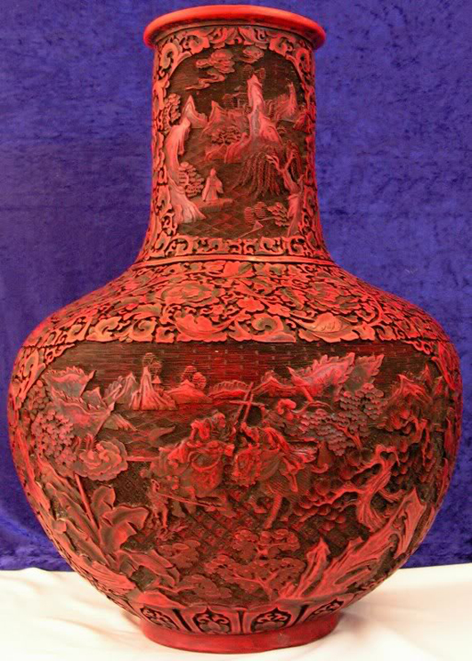 A crack runs vertically on one side of this carved cinnabar lacquer vase. The rare vase is 25 inches high by 20 inches in diameter. It has a $2,000-$10,000 estimate. Image courtesy Auction Ten.