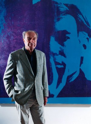 Ernst Beyeler in 2004 at the Beyeler Foundation in front of Andy Warhol's 'Self-Portrait.' Image courtesy Beyeler Foundation.