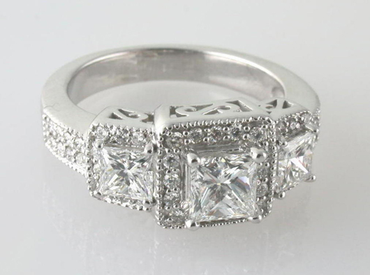 The center princess cut diamond on this while gold ring is about 1.53 carats. The GIA report state it has G color and S12 clarity. The estimate is $5,000-$6,000. Image courtesy Bunda Jewelry Appraisers and Auctioneers.