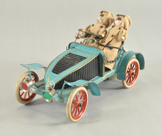 Circa-1900 hand-painted 12-inch tourer with race-style body, chained door sides, rubber tires, two bisque-head figures, original box and store tag, $14,000-$16,000. Image courtesy Bertoia Auctions.