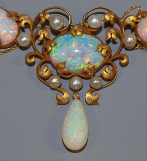 Important circa-1900 Art Nouveau necklace reputed to have once belonged to iconic American interior designer Elsie de Wolfe (a k a Lady Mendl, 1865-1950), comprised of more than 45 carats of cabochon, oval-cut and teardrop-shape Australian fire opals, 23 in all. Additional accents include 19 freshwater pearls and 52 single-cut diamonds. Retains original heart-shape leather case. Featured on Leigh and Leslie Keno’s TV show Find! Estimate $60,000-$80,000. Image courtesy of Austin Auction Gallery.