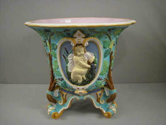 Panels of putti depicting Earth, Wind and Fire highlight this 20-inch-high Minton jardinière, which was once exhibited at the Walters Art Museum in Baltimore. It has a $6,000-$9,000 estimate. Image courtesy Michael G. Strawser Majolica Auctions.