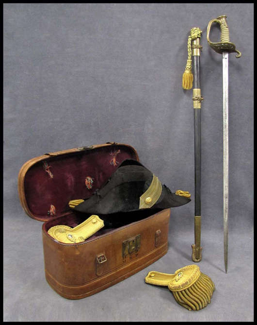 Military articles belonging to Commander H.L. Brown U.S.N., including model 1852 dress sword with scabbard; and to F.J. Heiberger, Washington D.C., including a pair of cased, full-dress epaulets, beaver chapeau, brass “dress” belt and buckle with sword hanger and leather case. Image courtesy William J. Jenack Auctioneers.