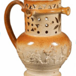Try drinking from this pierced puzzle jug without getting wet (use the handle as a straw). The 19th-century stoneware jug sold for $356 at a Skinner auction in Boston.