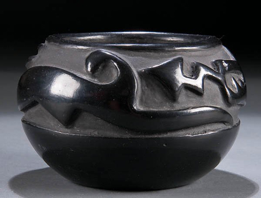 A deeply carved Avanyu serpent coils around this fine Santa Clara jar made by Margaret Tafoya. The 5 1/2-inch-diameter jar has a $2,500-$5,000 estimate. Image courtesy Jackson’s International Auctioneers & Appraisers.