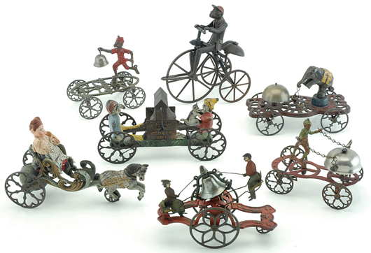 American cast-iron bell toys from the Spilhaus Collection, the highlight being a Gong Bell No. 24 Girl & Boy Bell Ringer (foreground), cast iron with tin figures, est. $2,500-$3,500. Noel Barrett Auctions image.