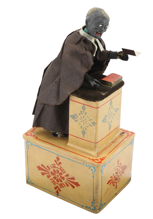 Ives Preacher, cloth-dressed figure at velvet-covered pulpit with composition head, original wire eyeglasses, cast-iron feet and tin hands. Retains original wood box with partial paper label. Estimate $4,000-$5,000. Noel Barrett Auctions image.