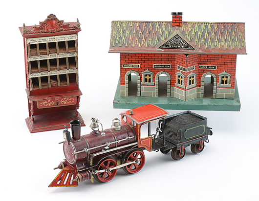 Marklin railroad rarities including a ticket kiosk with U.S. destinations, O gauge station and gauge 1 set featuring American steam profile 0-4-0 clockwork engine, locomotive and (not shown) boxcar and two passenger cars. Gauge 1 set estimate $15,000-$20,000. Noel Barrett Auctions image.