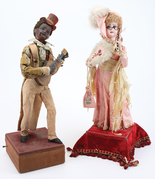 Large Lambert lady automaton with a marked “Depose Tete Jumeau” bisque head (est. $6,000-$8,000) and circa-1890 Lambert or Vichy black man musician automaton with painted bisque head, curly-haired wig and wood guitar (est. $6,000-$8,000). Noel Barrett Auctions image.