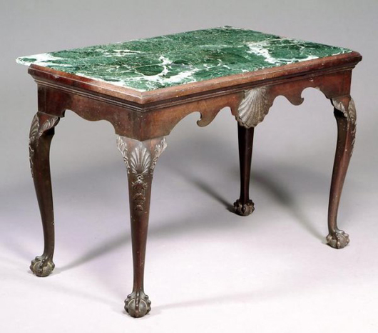 A mottled green inset marble top sets off this Irish George III mahogany side table, circa 1760. It is estimated at $6,100-$9,200. Image courtesy Dreweatts.