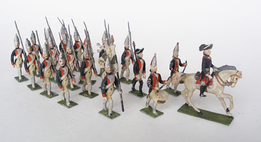 Riding a white horse, Frederick the Great leads his troops to the accompaniment of two drummers in this beautiful set of soldiers made by Haffner. Old Toy Soldier Auctions image.