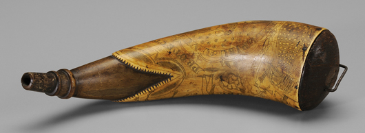 A slightly larger Tim Tansel powder horn sold at Cowan’s in May 2007. Tansel signed and extensively engraved this 9-1/8 inch horn and included his typical serrated fish-mouth edge at the wood plug end. Estimate: $2,000/$4,000. Brunk Auctions image.