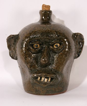 China plate teeth face jug, late 1960s, attributed to Lanier Meaders, could have been made by Cheever, estimate: $3,000-$5,000. Image courtesy of Slotin Auction.
