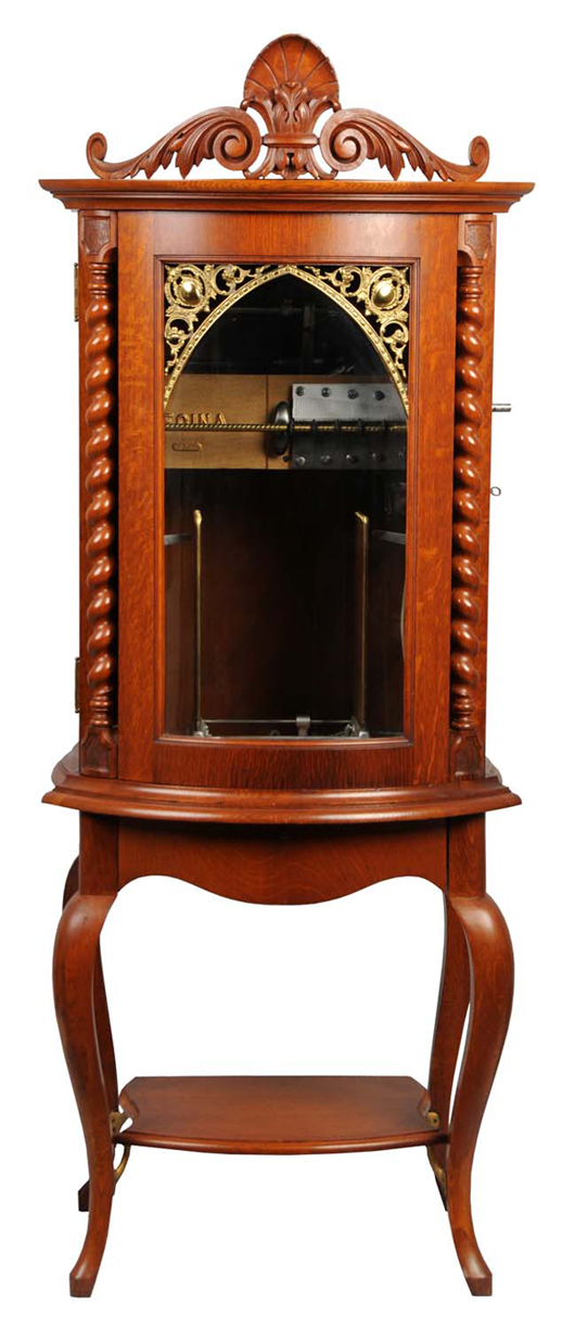 Regina 67½ inch tall double-comb music box with bow-front oak case and marquee. Includes 90 15½ inch metal discs. In fine working order. $20,000-$30,000. Dan Morphy Auctions image.